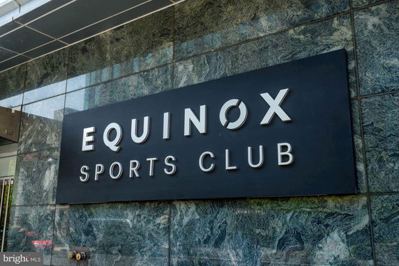 Front view of a sports club building with a large sign.