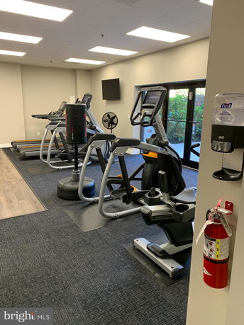 Indoor gym area with exercise equipment including treadmills and ellipticals.