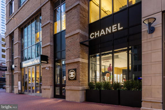 Front view of a commercial building with Abercrombie & Fitch and Chanel stores.