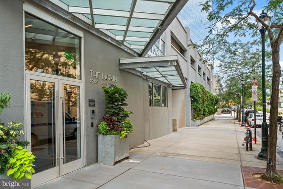 Front view of a modern building with glass doors and canopy.