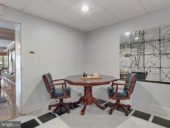 Room with a small table and two chairs for recreational activities.