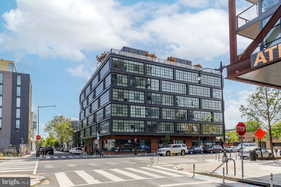 Front view of a modern multi-story building with large grid windows.