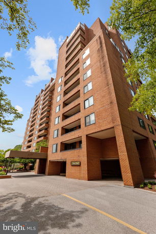 Front view of a multi-story brick apartment building.