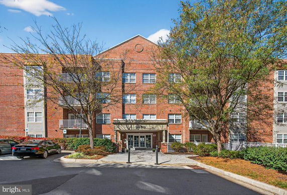 Front view of a multi-story brick apartment building.