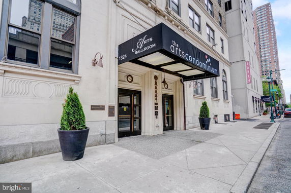 Front view of a condominium building with an entrance canopy.