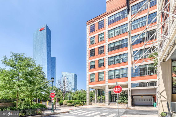 Front view of a multi-story building with large windows and brick exterior.