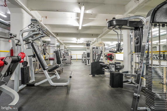 Indoor gym area with various exercise machines and equipment.