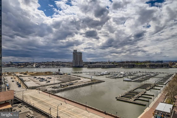Wide angle view of a waterfront area with a marina and buildings in the background.