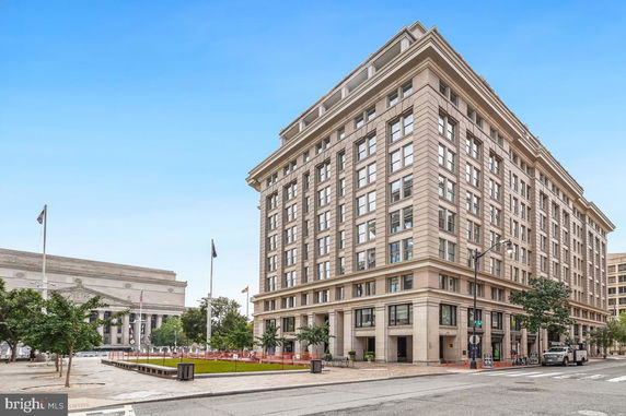 Front view of a multi-story office building with large windows.