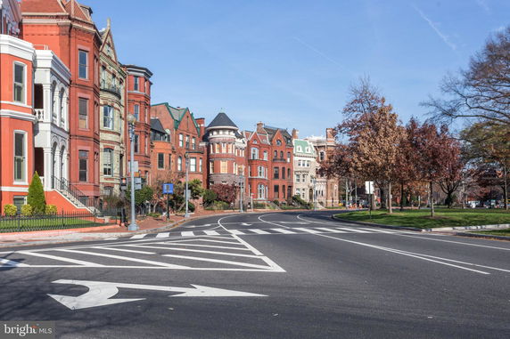 Front view of a row of historic houses on a city street.