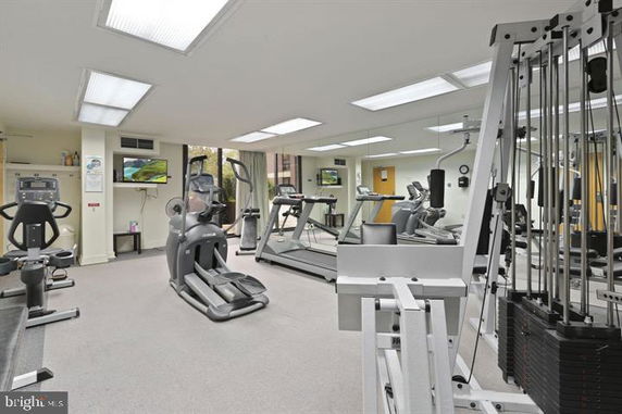 Indoor gym area with exercise equipment and mirrors.