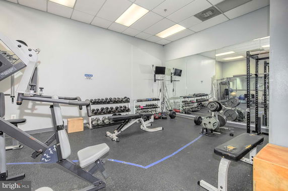 Indoor gym area with exercise equipment and weights
