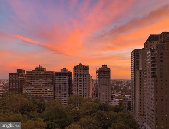 Panoramic view of buildings against a colorful sunset sky.