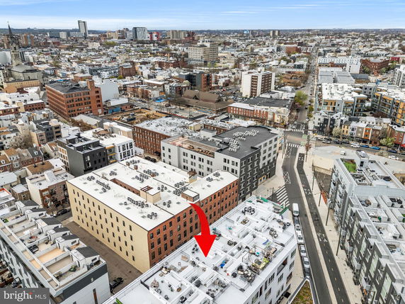 Panoramic view of a cityscape with multiple buildings and roads.
