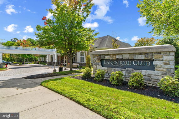 Front view of a building with a stone facade and a sign reading 'Lakeshore Club'.
