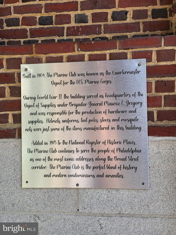 Plaque on a brick exterior of a historical building.