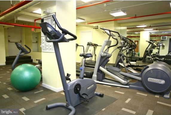 Indoor gym area with exercise bikes and elliptical machines.
