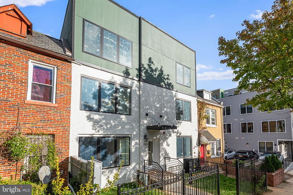 Front view of a multi-story building with large windows and a modern design.