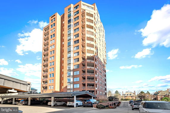Front view of a high-rise building with multiple balconies.