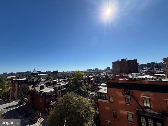 Wide-angle view of a cityscape with multiple buildings under a clear sky.