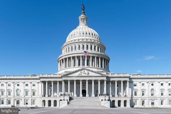 Front view of a large historic domed building with intricate architectural details.