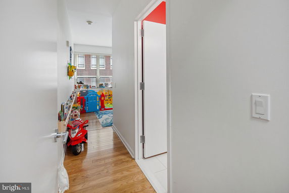 View of a hallway leading to an indoor play area with toys and books.