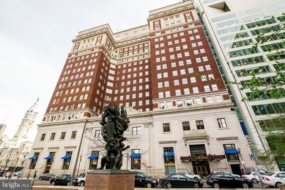 Front view of a large multi-story building with brick and stone facade.