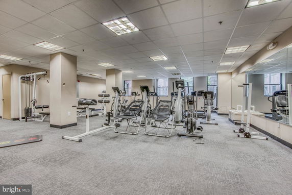 Indoor gym area with exercise equipment such as stationary bikes and benches.