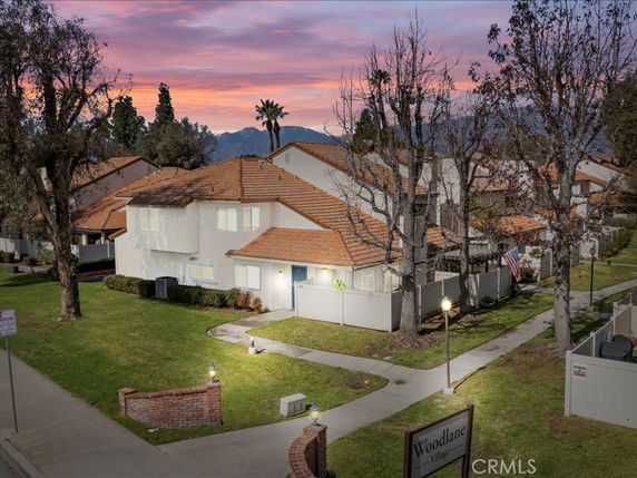 Front view of a multi-story residential building with a red-tiled roof.