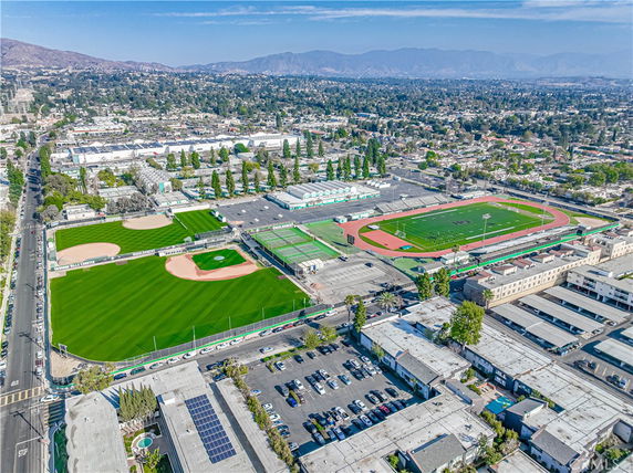 Aerial view of sports complex with baseball fields, a track, and a football field.