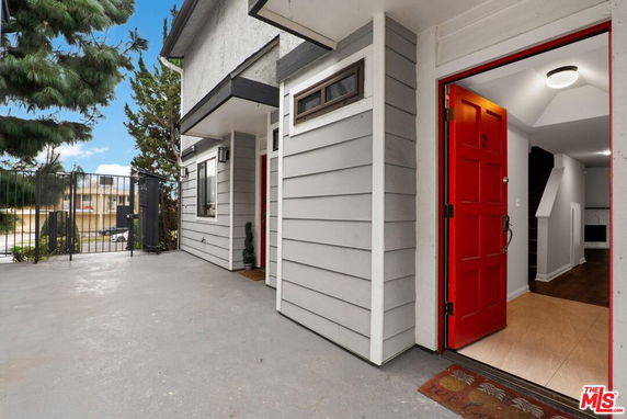 Front view of a building entrance with a red door.