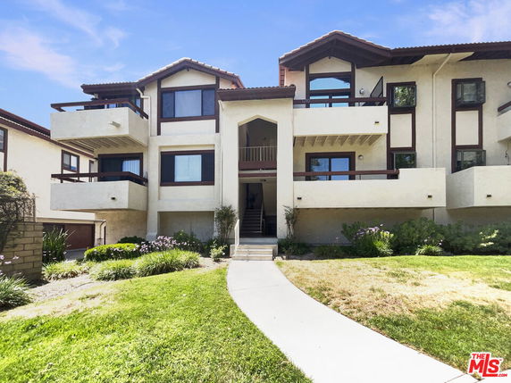Front view of a multi-story residential building with balconies.