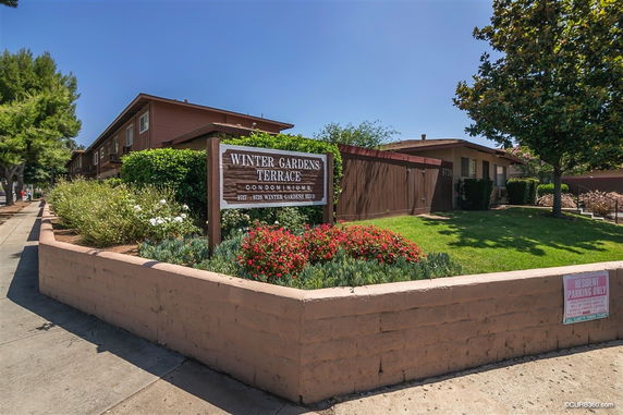 Front view of a two-story condominium building named Winter Gardens Terrace.
