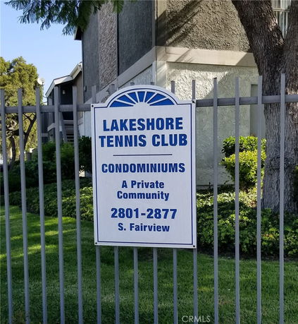 Front view of a condominium building with a sign for Lakeshore Tennis Club.