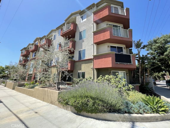 Front view of a multi-story apartment building with balconies.