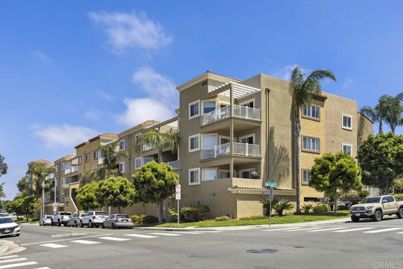 Front view of a multi-story apartment building with balconies.