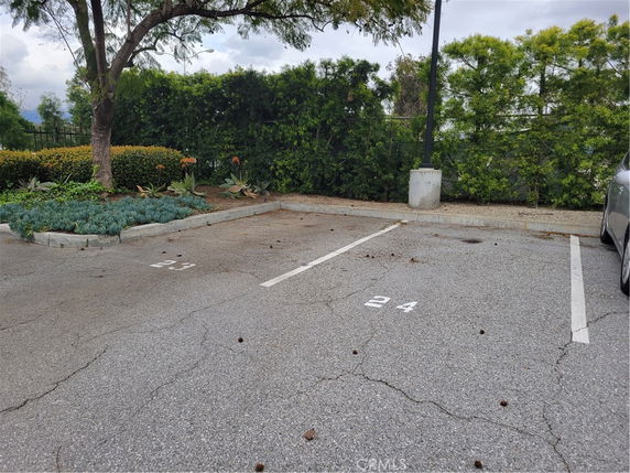 Outdoor parking area with marked parking spaces 23 and B4.