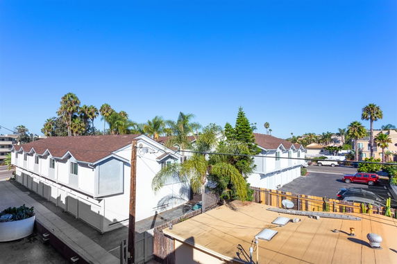 View of surrounding residential buildings and parking lot.
