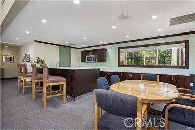 Interior of a clubhouse with seating area and counter.