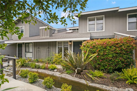 Front view of a two-story house with a garden.