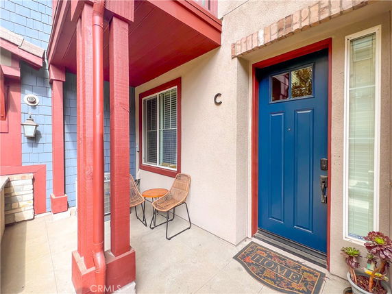 Front view of a house entrance with a blue door and red trim.