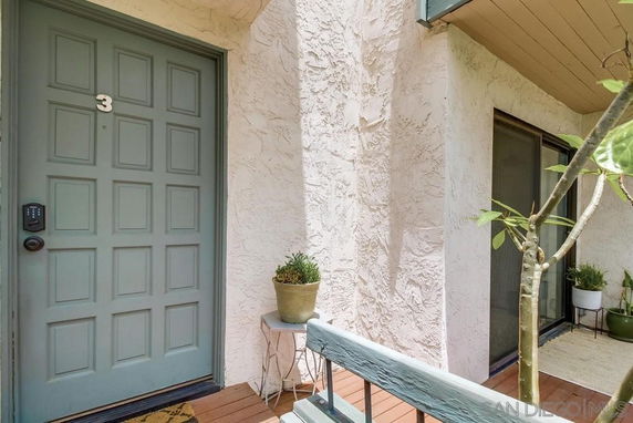 Entryway view of a house with a textured wall and a door marked with the number 3.