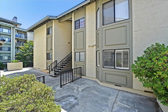 Front view of a multi-story building with exterior stairs.