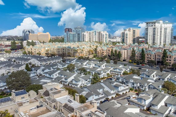 Panoramic view of a cityscape with residential and high-rise buildings.