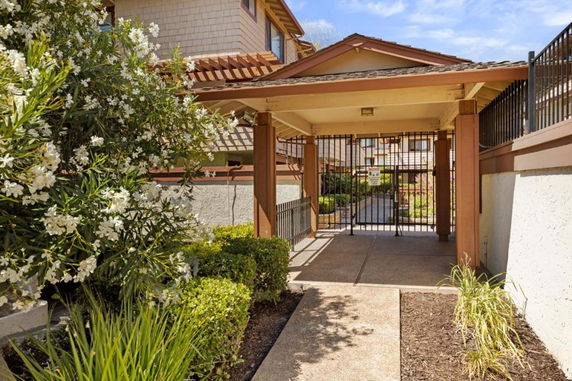Entrance of a building with a gated walkway and overhang.
