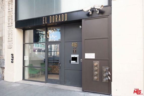 Front view of a building entrance with 'El Dorado' signage and security cameras.