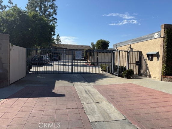 Front view of a gated residential complex with single-story buildings.