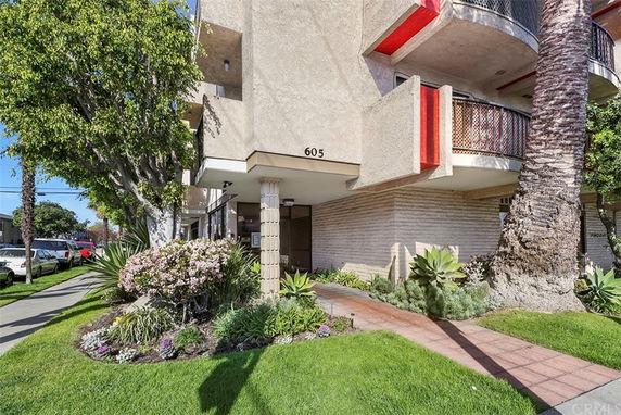 Front view of a multi-story residential building with balconies