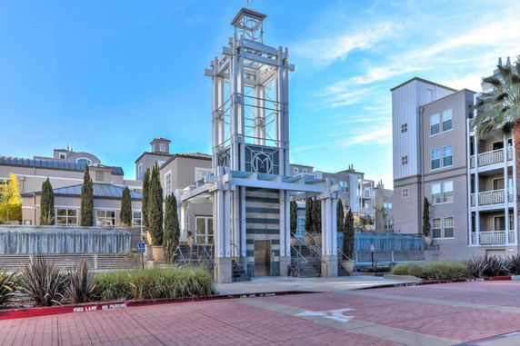 Front view of a multi-story apartment complex with modern architectural design.