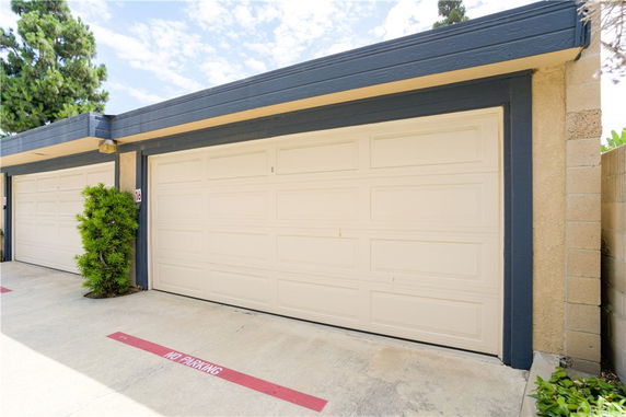 Garage with a closed door and 'no parking' zone in front.